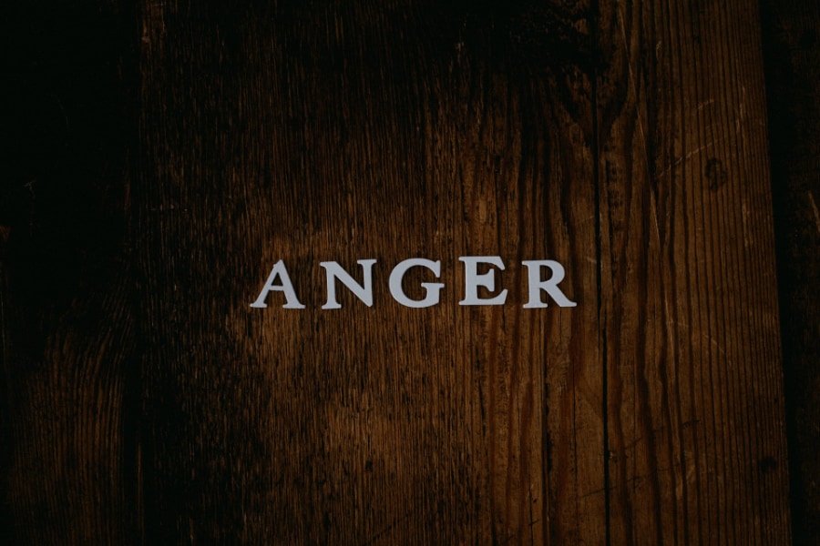 The capital letters for anger laid out on a wooden table